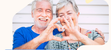 couple making a heart with their fingers